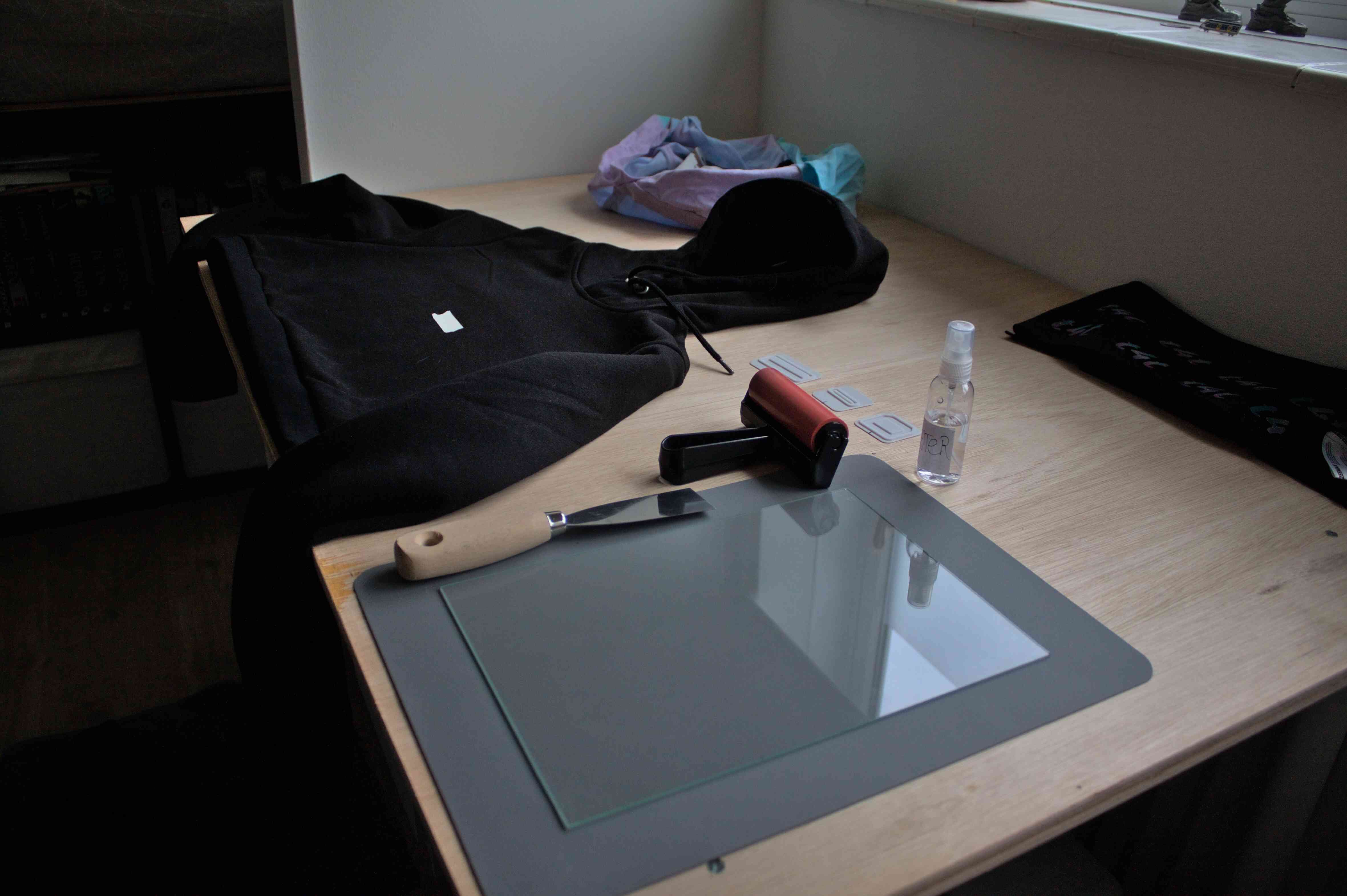 A table with a black hoodie and the various tools described above