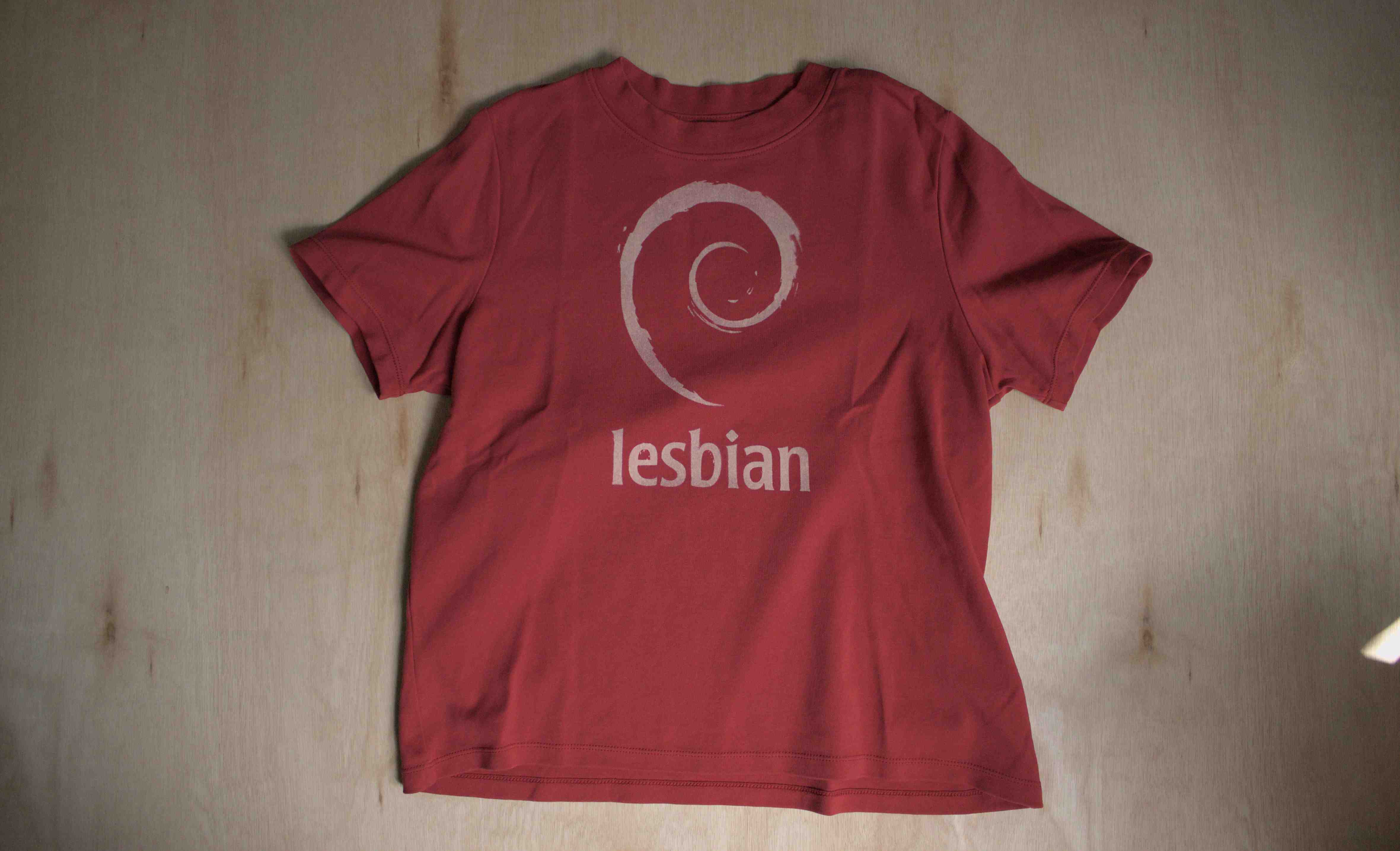 Red shirt with the debian logo and the text "lesbian"