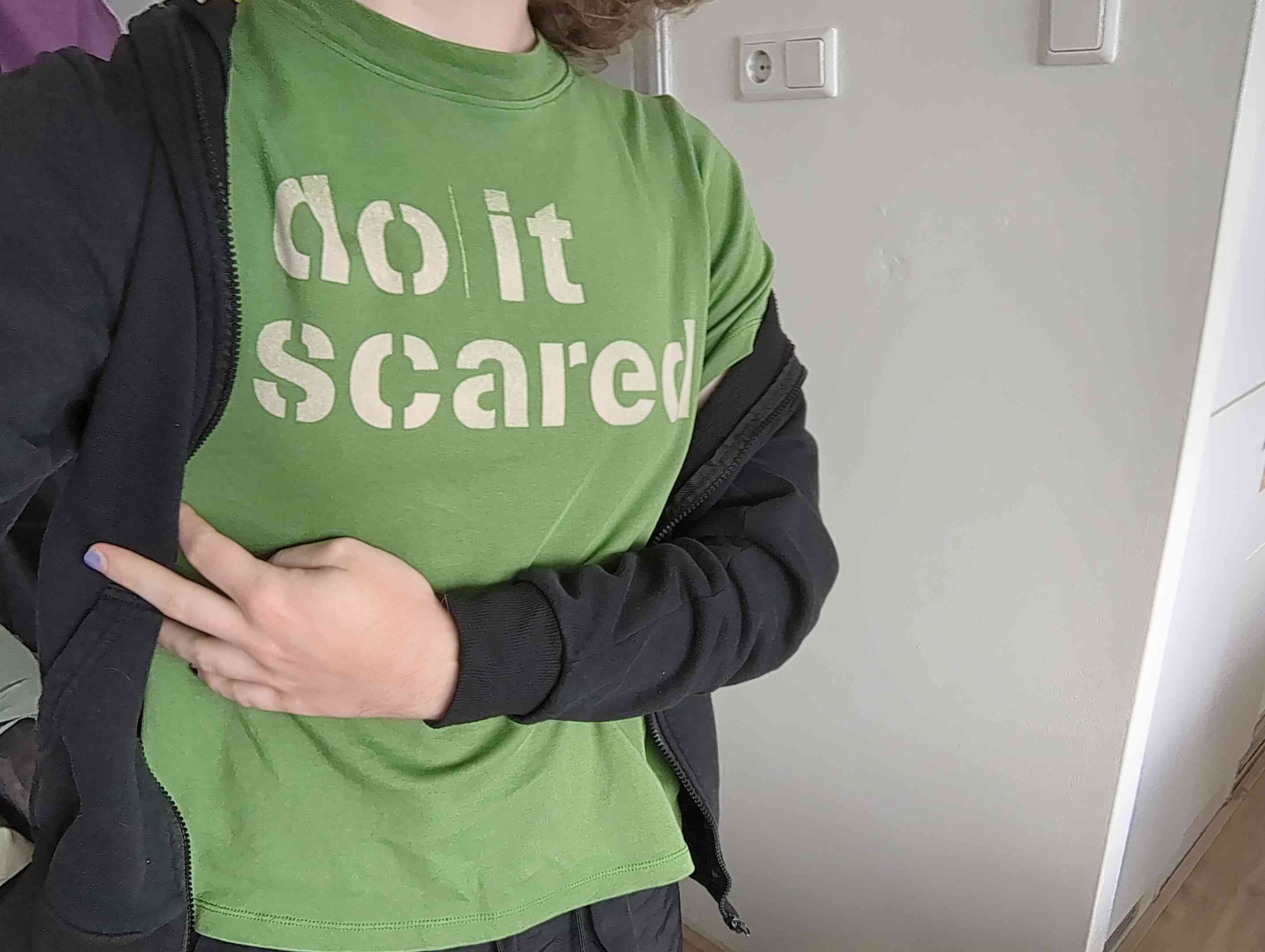 green shirt that says "do it scared"